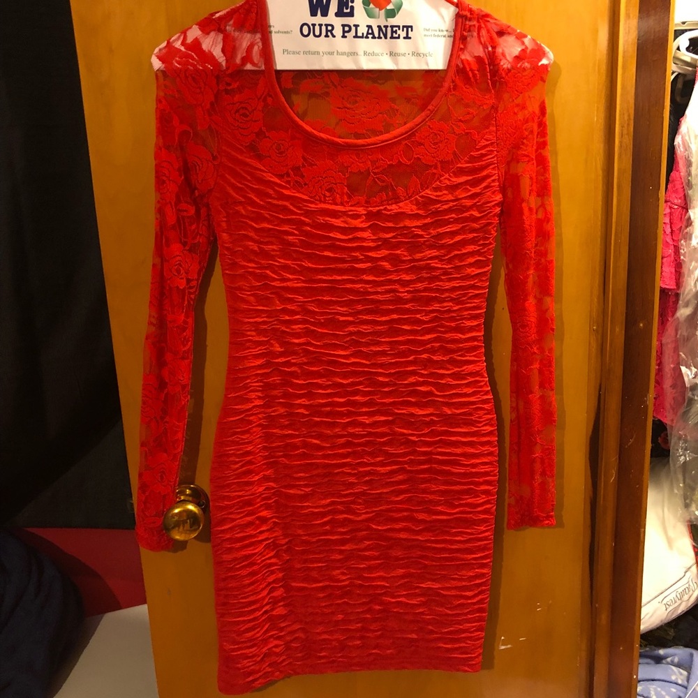 Form fitting red long sleeve dress.